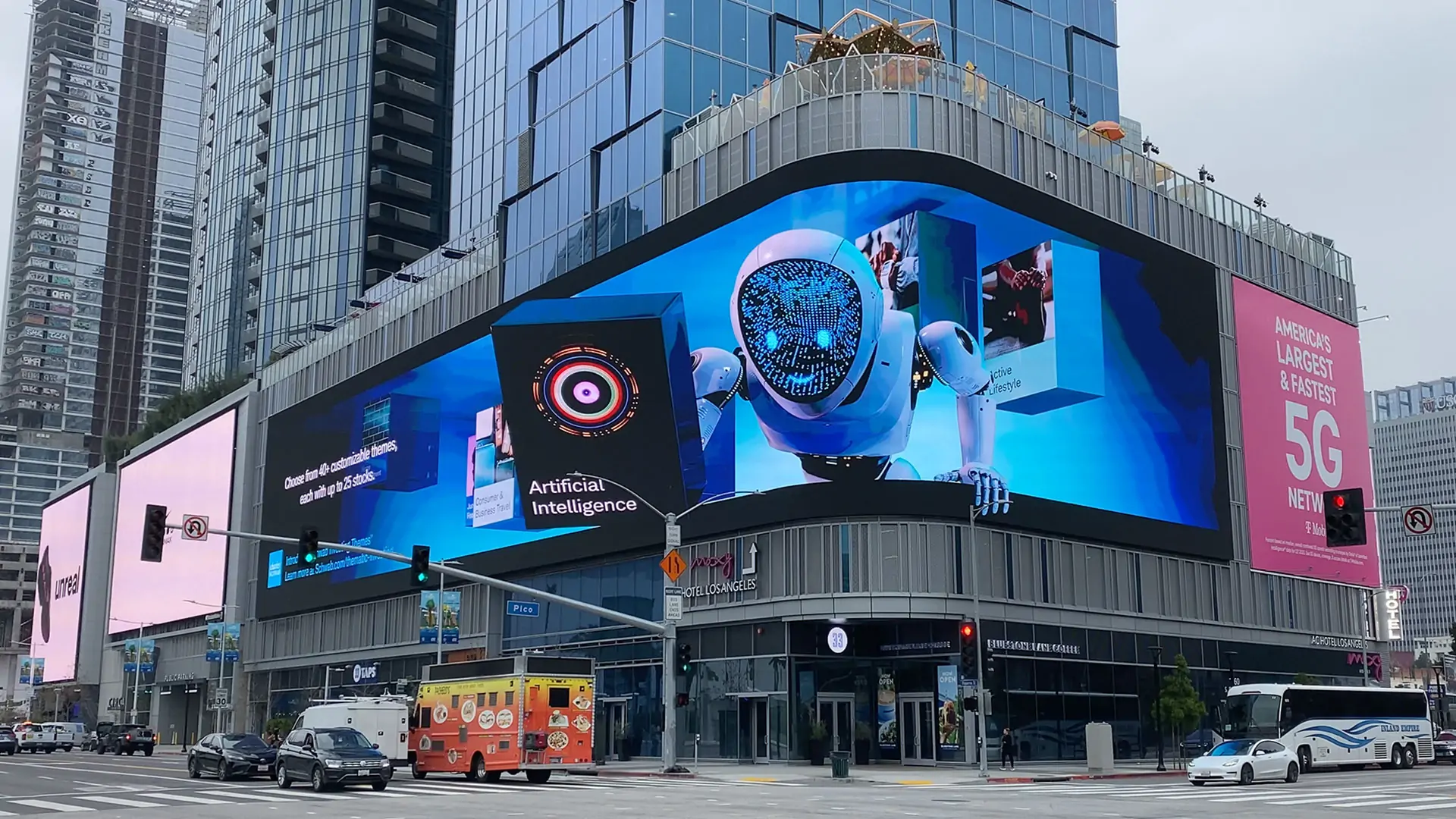 3D Anamorphic Billboards LED Display Manufacturer in China EagerLED Large curved digital billboard on a glass fronted building displaying a blue robot image city street with vehicles below