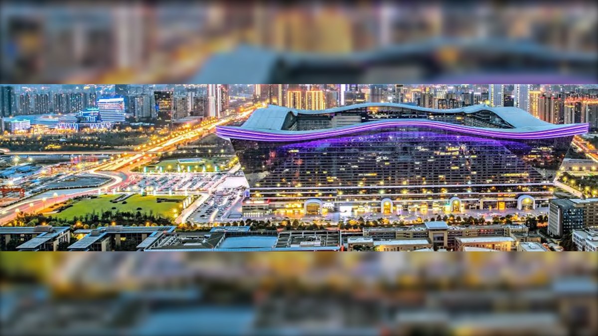 12 New Century Global Center Biggest LED Screen Project LED Display Manufacturer in China EagerLED Night view of a futuristic stadium with purple neon accents beside a city skyline at duskmoonrise hours