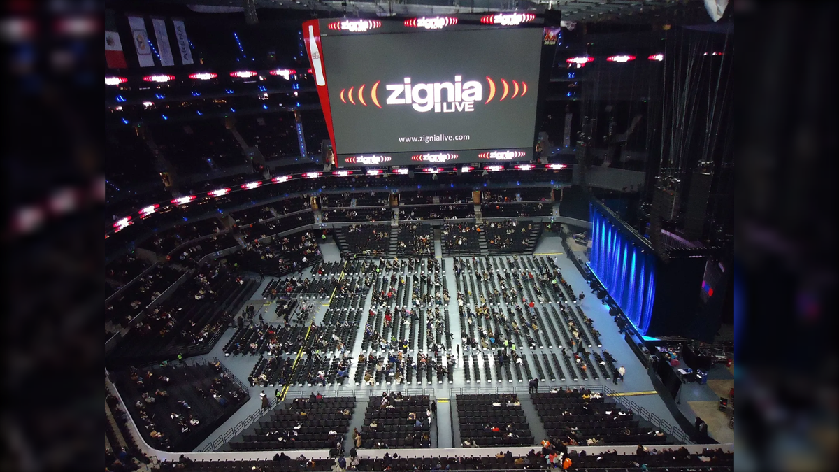 Arena Ciudad de Mexico Biggest LED Screen Project LED Display Manufacturer in China EagerLED Large indoor arena with a giant screen showing Zignia Live and a mostly empty seating area gathering for an event