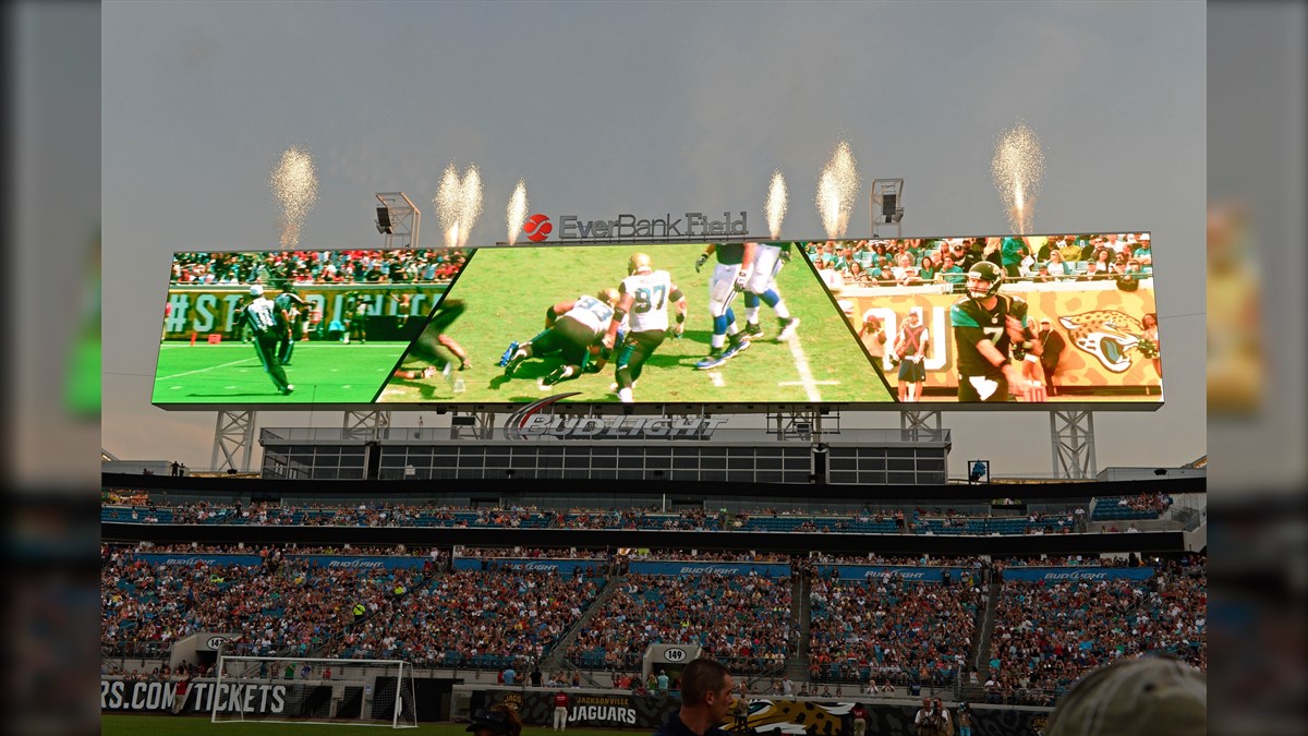 EverBank Stadium Displays Biggest LED Screen Project LED Display Manufacturer in China EagerLED Large stadium scoreboard at EverBank Field showing multiple football plays with crowd in the stands and fireworks in the sky above