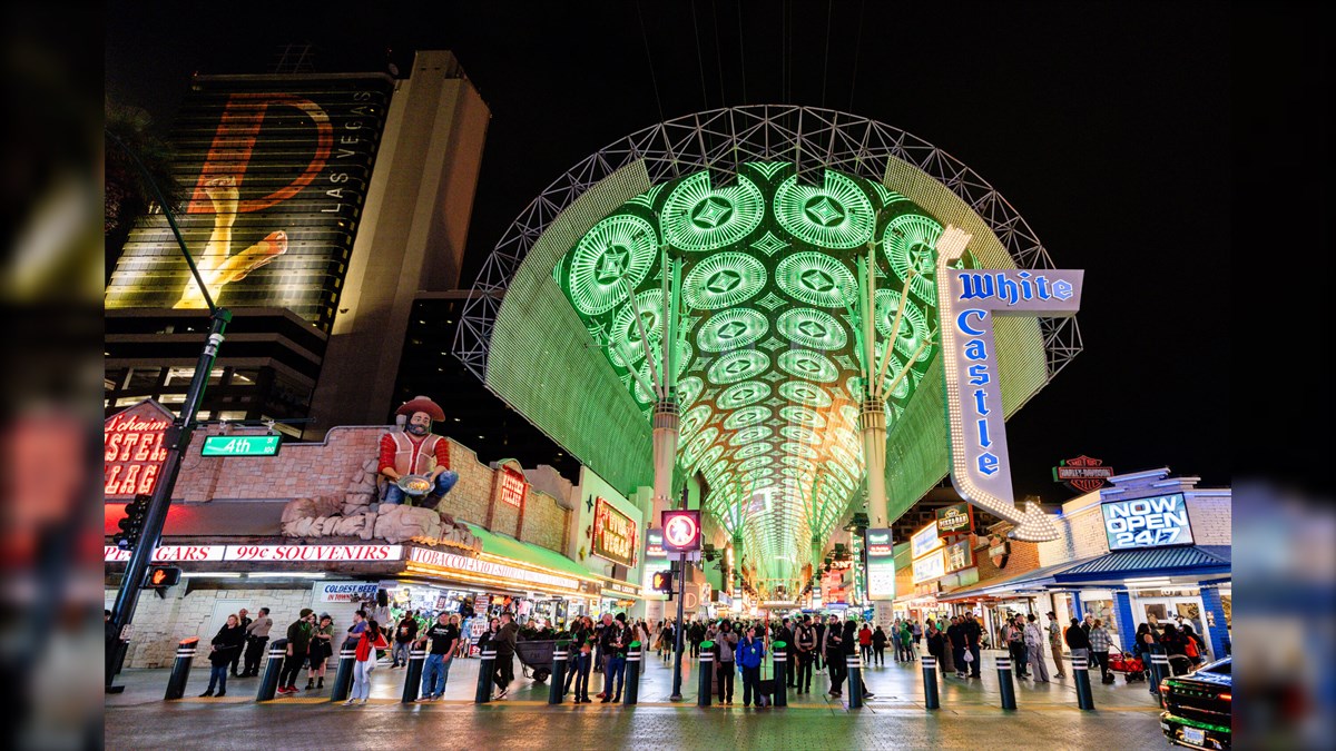 Fremont Street Viva Vision Biggest LED Screen Project LED Display Manufacturer in China EagerLED Night scene at Fremont Street Las Vegas a bright green LED canopy over a busy pedestrian mall with shops and crowds