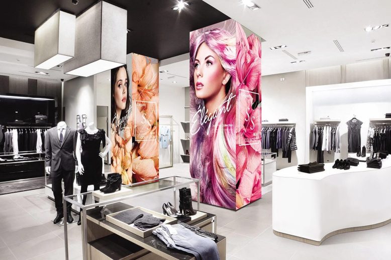 Commercial LED display columns used as retail store signage in a clothing shop