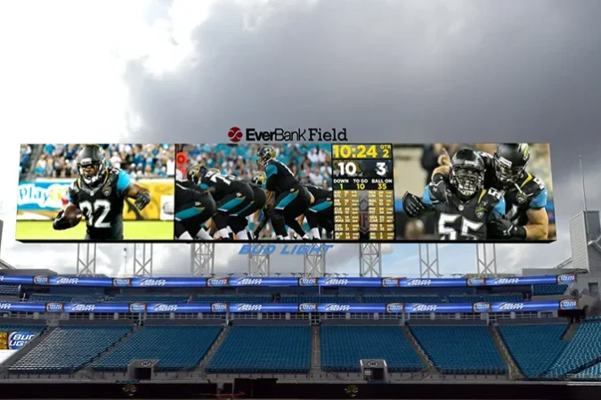 Wide Jumbotron scoreboard above outdoor stadium seating