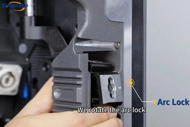 Technician rotating the arc lock between two EA500C6 rental LED cabinets to set the curve angle