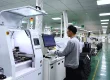 Operator running the SMT line that mounts components on LED module PCBs at the EagerLED factory