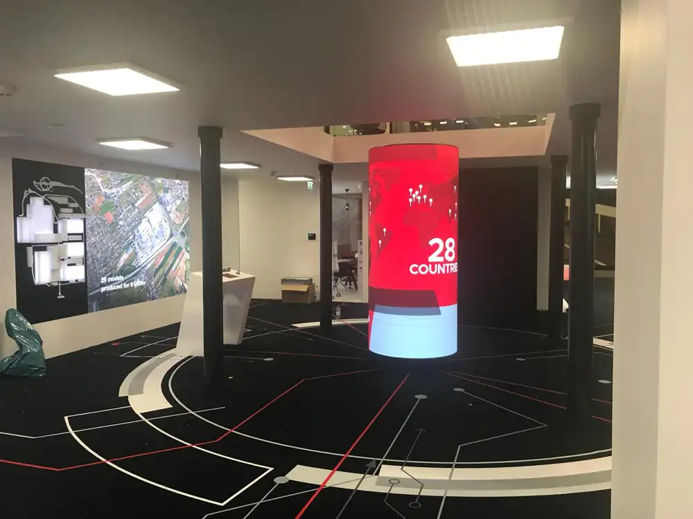 Indoor cylindrical LED screen built from EA-Flex flexible LED modules in a showroom in Austria