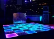 LED video dance floor with glowing tiles in a nightclub