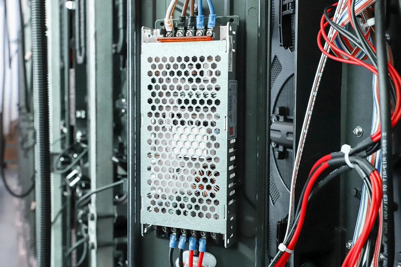 LED display power supply mounted inside a cabinet with connected wiring